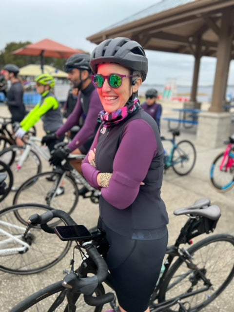 woman on a bike folding her arms