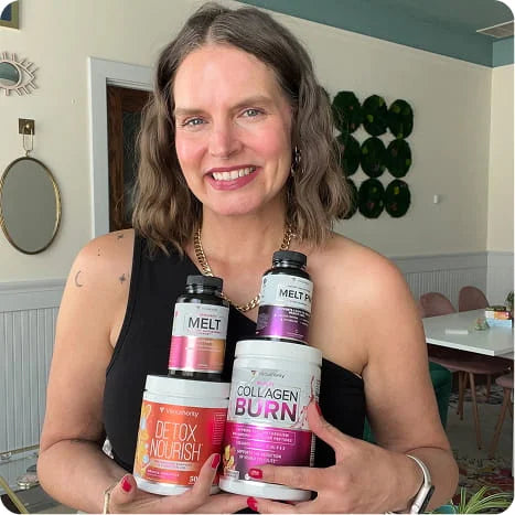 A smiling woman with shoulder-length brown hair holds four supplement containers in a home setting. The products include Meltz Melt, Meltz Collagen Burn, Detox Nourish, and Collagen Burn by Vitality.