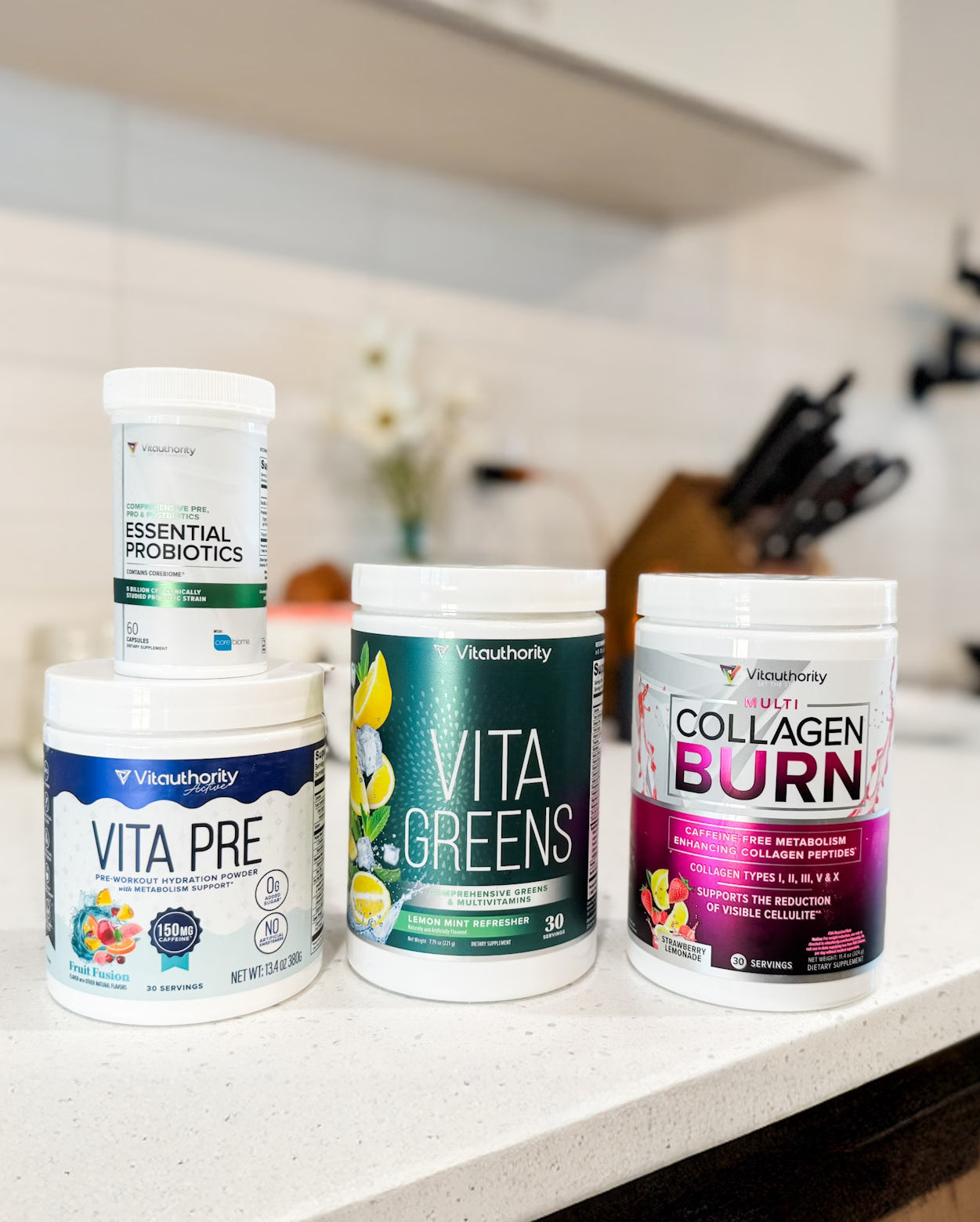 Four Vitauthority supplement containers on a kitchen counter